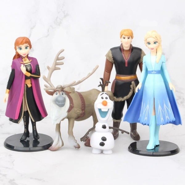 Figuren aus Die Schneekönigin, die nebeneinander stehen und zu uns herüberschauen Elsa Anna Olaf