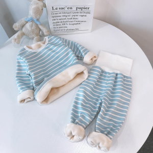 Gestreifter Fleece-Pyjama für Mädchen mit einem Teddybär auf einem Tisch in einem Haus