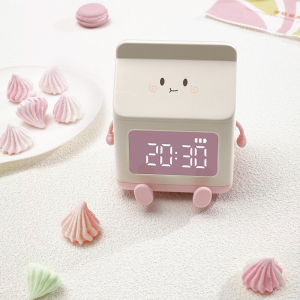 Radiowecker in Form einer kreativen Milchkanne für Mädchen mit weißem Hintergrund und Süßigkeiten an der Seite